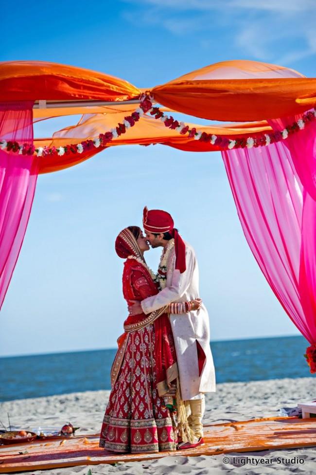 Couple kissing in outdoor beach portrait 