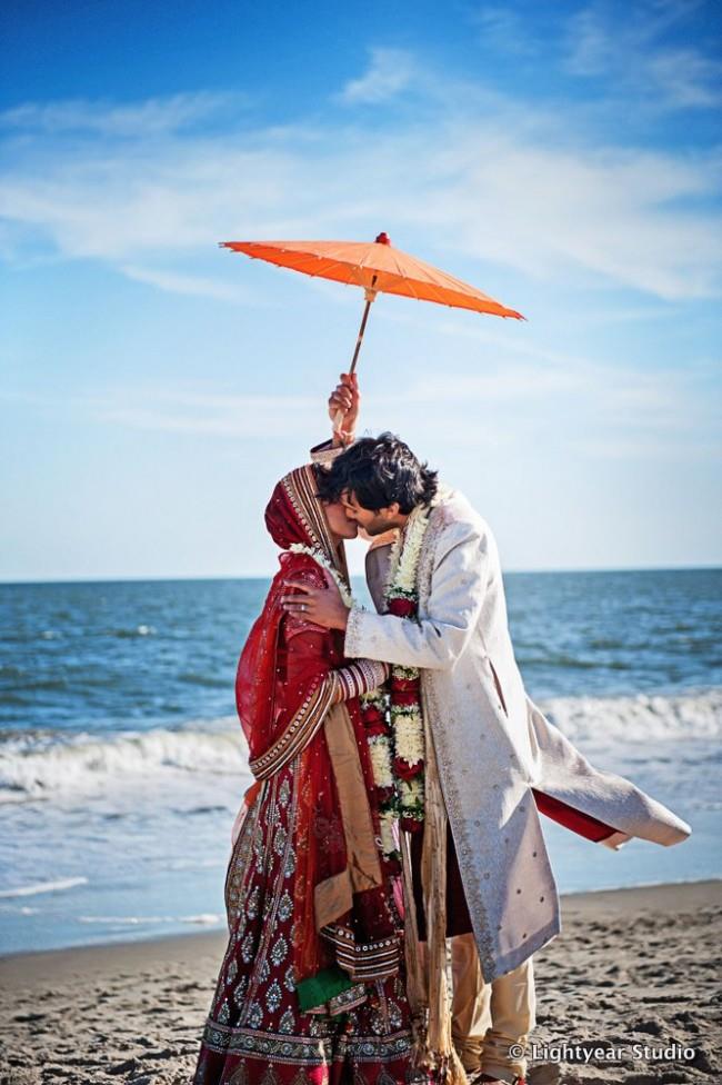 Couple kissing with orange umbrella