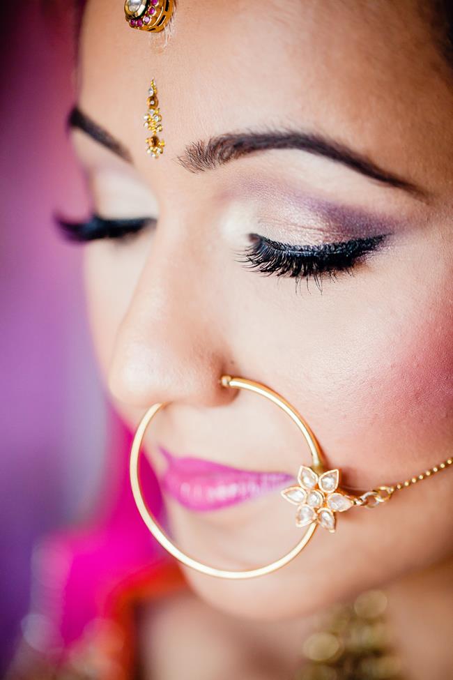 Closeup of Indian bride makeup and gold round nose ring nath