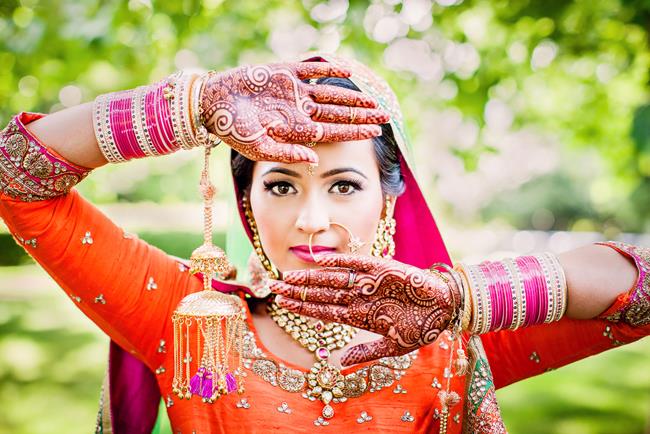 Portrait of Punjabi Indian bride with kaleeray churra and mehndi
