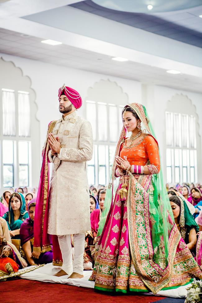 Sikh couple standing during Anand Karaj