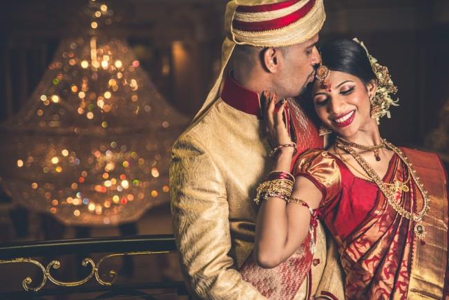 29a indian wedding bride and groom kissing reception portrait