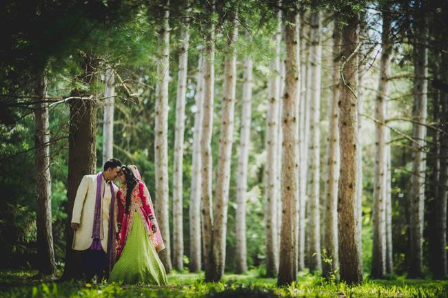 Indian couple portrait outdoors with tall trees