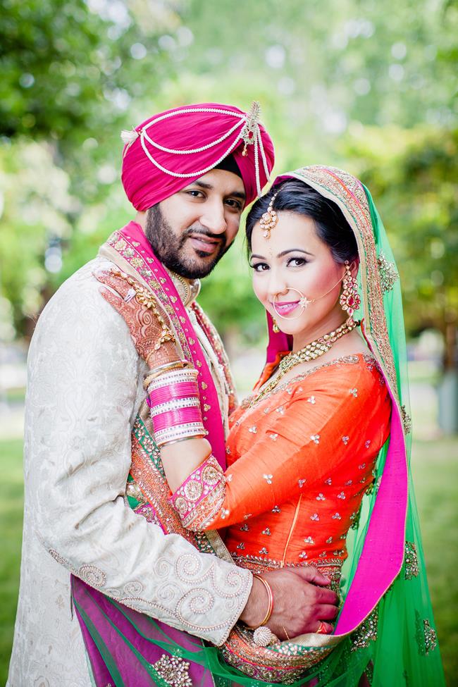 Punjabi bride and groom in pink and orange